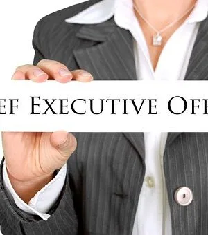 Chief Executive Officer text held by a person in a business suit.